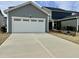 A spacious two-car garage featuring a concrete driveway and dark accents at 1981 Rosedale Ridge Ave, Wake Forest, NC 27587