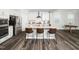Modern kitchen island with sleek stools, stainless steel appliances, and ample counter space at 1981 Rosedale Ridge Ave, Wake Forest, NC 27587