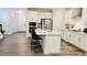 Bright kitchen featuring white cabinets, stainless steel appliances, and a spacious center island with seating at 1981 Rosedale Ridge Ave, Wake Forest, NC 27587