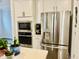 Bright kitchen with stainless steel appliances, white cabinets, and modern fixtures at 1981 Rosedale Ridge Ave, Wake Forest, NC 27587