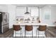 Bright, modern kitchen with stainless steel appliances and a large kitchen island with barstool seating at 1981 Rosedale Ridge Ave, Wake Forest, NC 27587