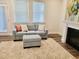 Relaxing living room with a comfortable blue sofa, cozy rug, and an elegant fireplace, creating a serene atmosphere at 1981 Rosedale Ridge Ave, Wake Forest, NC 27587