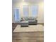 Comfortable living room showcasing a couch, ottoman, rug, and natural light from windows at 1981 Rosedale Ridge Ave, Wake Forest, NC 27587
