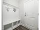 Mudroom with white painted storage bench and hooks at 1981 Rosedale Ridge Ave, Wake Forest, NC 27587