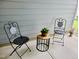 Cozy porch with decorative chairs and a small table, ideal for relaxing outdoors at 1981 Rosedale Ridge Ave, Wake Forest, NC 27587