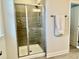 Tiled shower with glass door, rain shower head, and built in shelving at 1981 Rosedale Ridge Ave, Wake Forest, NC 27587