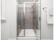 Glass-enclosed shower with gray-tiled walls, bench, and modern shower head at 1981 Rosedale Ridge Ave, Wake Forest, NC 27587