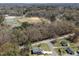 An aerial view of a home nearby a baseball and tennis park on a clear day at 202 Harper Rd, Hillsborough, NC 27278