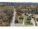 An aerial view of a home, detached garages, and a lightly wooded area at 202 Harper Rd, Hillsborough, NC 27278