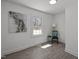 A bedroom featuring a window view, art on the walls, and wood-look flooring at 202 Harper Rd, Hillsborough, NC 27278