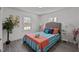 A bedroom featuring a bed with decorative pillows, two windows, and art on the wall at 202 Harper Rd, Hillsborough, NC 27278