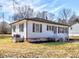 A cozy, quaint home featuring multiple windows and a lovely yard at 202 Harper Rd, Hillsborough, NC 27278