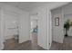 Hallway with a view to a bathroom and a living room, with consistent flooring and white walls at 202 Harper Rd, Hillsborough, NC 27278