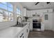 Modern kitchen with stainless steel appliances, white cabinets, and marble countertops at 202 Harper Rd, Hillsborough, NC 27278