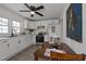 Well-lit kitchen with white cabinets, stainless steel appliances, and a cozy dining table at 202 Harper Rd, Hillsborough, NC 27278