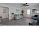 Cozy living room with gray walls, comfortable seating, and a stylish ceiling fan at 202 Harper Rd, Hillsborough, NC 27278
