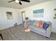 Bright living room featuring gray flooring, cozy sofa, and eye-catching decor at 202 Harper Rd, Hillsborough, NC 27278