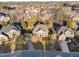 Impressive aerial view of a grand home with stately columns and a beautifully landscaped front yard in a suburban neighborhood at 2110 Crigan Bluff Dr, Cary, NC 27513