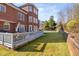 Large, well-maintained backyard with a deck, lawn, and brick home exterior at 2110 Crigan Bluff Dr, Cary, NC 27513