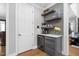 Chic bar area with floating shelves, a wine cooler, and modern finishes at 2110 Crigan Bluff Dr, Cary, NC 27513