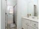 Bright bathroom featuring a white vanity with marble countertop and a shower with a patterned curtain at 2110 Crigan Bluff Dr, Cary, NC 27513