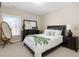 Comfortable bedroom featuring neutral walls, carpeted floors, and natural light from the window at 2110 Crigan Bluff Dr, Cary, NC 27513