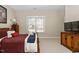 Cozy bedroom with carpet, a window with blinds, and wood furniture, creating a relaxing atmosphere at 2110 Crigan Bluff Dr, Cary, NC 27513