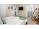 Bright bedroom featuring a mounted TV and a view into an adjacent bathroom at 2110 Crigan Bluff Dr, Cary, NC 27513