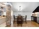 Cozy dining area next to a partial stone wall and adjacent to a kitchenette and bar at 2110 Crigan Bluff Dr, Cary, NC 27513