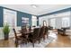 Elegant dining room with wainscoting, stylish decor, and a view into the living space at 2110 Crigan Bluff Dr, Cary, NC 27513