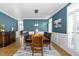 Formal dining room featuring a large wooden table, sophisticated wall color, and natural light at 2110 Crigan Bluff Dr, Cary, NC 27513