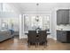 Open-concept dining area with natural light, a view into the living room and modern light fixture at 2110 Crigan Bluff Dr, Cary, NC 27513