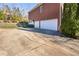 Brick home with a three-car garage and a spacious driveway and landscaped yard at 2110 Crigan Bluff Dr, Cary, NC 27513