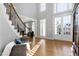 Bright and airy foyer with hardwood floors, staircase, and an abundance of natural light at 2110 Crigan Bluff Dr, Cary, NC 27513