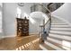Elegant foyer featuring a curved staircase with iron railings and hardwood floors at 2110 Crigan Bluff Dr, Cary, NC 27513