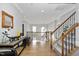 Elegant foyer with hardwood floors, a staircase, and a view of the upper-level hallway at 2110 Crigan Bluff Dr, Cary, NC 27513