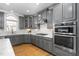 Stylish kitchen featuring gray cabinetry, modern appliances, and a spacious layout at 2110 Crigan Bluff Dr, Cary, NC 27513