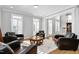 Comfortable living room with leather chairs, a plush rug, and ample natural light at 2110 Crigan Bluff Dr, Cary, NC 27513