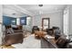 Well-appointed living room with leather chairs, a dark wood table, and an adjacent dining area at 2110 Crigan Bluff Dr, Cary, NC 27513