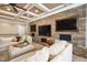 Comfortable living room with a stone accent wall, coffered ceiling, and plush sofas at 2110 Crigan Bluff Dr, Cary, NC 27513