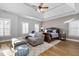 Bright main bedroom with tray ceilings, a cozy sitting area, and natural light from shuttered windows at 2110 Crigan Bluff Dr, Cary, NC 27513