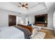 Tranquil main bedroom with tray ceilings, a sliding barn door, and a cozy sitting area with a TV at 2110 Crigan Bluff Dr, Cary, NC 27513