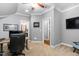 Functional home office featuring an adjustable desk, neutral colors and an attached bathroom at 2110 Crigan Bluff Dr, Cary, NC 27513