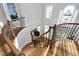 Elegant curved staircase featuring hardwood steps, iron railings and a bright, sunlit landing at 2110 Crigan Bluff Dr, Cary, NC 27513