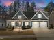 Charming two-story home features a three-car garage, and well-manicured lawn at 2111 Meadowcreek Dr, Durham, NC 27705