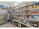 Well-stocked pantry features open shelving, stainless steel fridge, and plenty of storage at 2111 Meadowcreek Dr, Durham, NC 27705