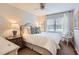 Bedroom with white bedding, ceiling fan, and natural light through the window at 212 Sampson St, Raleigh, NC 27609