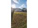 Grassy backyard enclosed by a black metal fence with a shed, offering privacy and security at 23 Tullamore Ln, Four Oaks, NC 27524