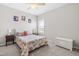 Bright bedroom showcasing a charming bed with colorful quilt and a sunny window at 23 Tullamore Ln, Four Oaks, NC 27524