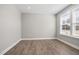 Bedroom with wood floor, neutral paint, and a large window bringing in lots of natural light at 2321 Calluna Ct, Fuquay Varina, NC 27526